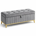 Banc de rangement en velours gris avec pieds en métal doré